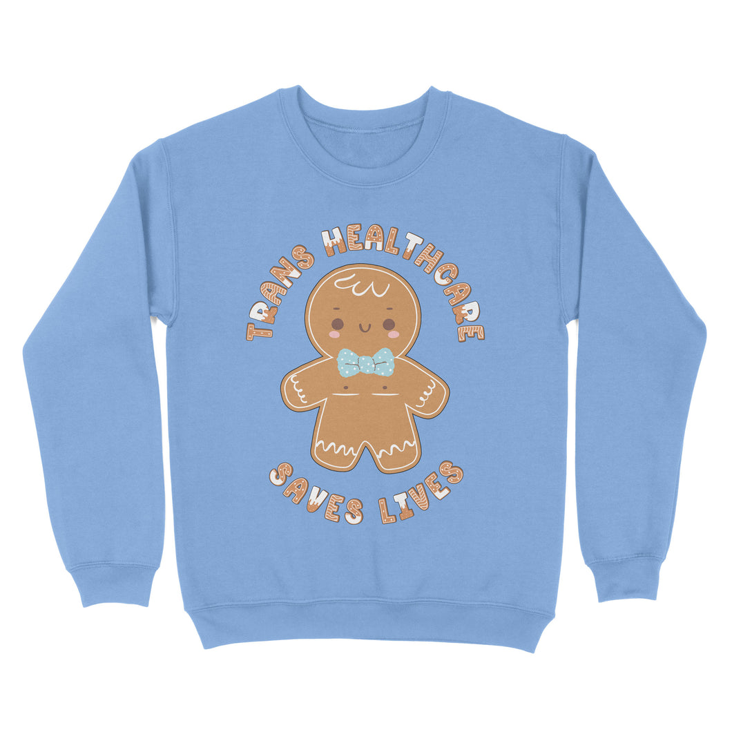 Cornflower blue sweatshirt with a gingerbread person design and the text 'Trans Healthcare Saves Lives' in holiday-themed typography.