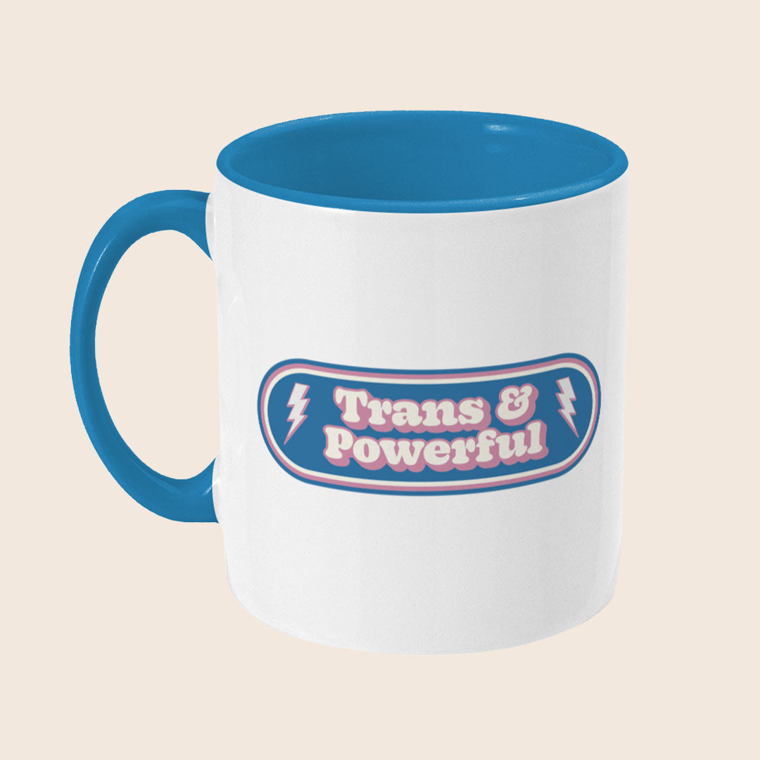 Angled side view of Trans & Powerful mug showing blue handle, coloured interior, and lightning bolt details in the design