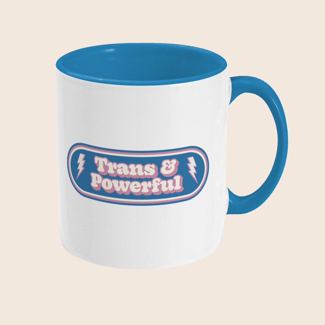 Reverse view of Trans & Powerful mug displaying wraparound design on a white ceramic mug with blue handle and interior