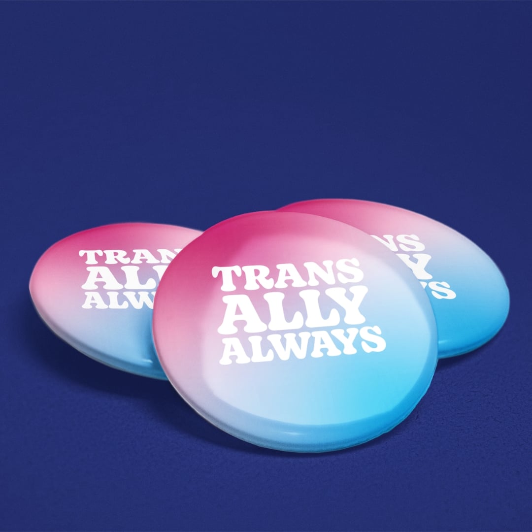 Three 38mm Trans Ally Always badges displayed on a dark blue background showing pink, white and blue gradient design.