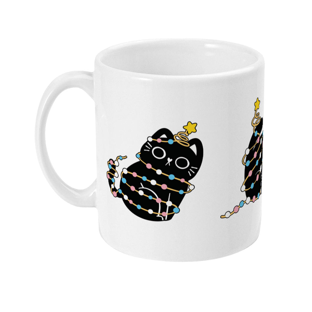 Side view of a white mug displaying a black cat sitting upright, adorned with pastel blue, pink, and white Christmas lights. A small yellow star rests atop the cat’s head.