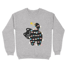 Load image into Gallery viewer, Heather grey sweatshirt with a playful black cat wrapped in Christmas lights inspired by the transgender pride flag, holding up its tail with a star decoration.