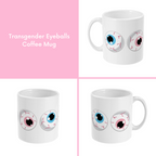 A composite image of a white coffee mug with a cartoon eyeball design in transgender pride flag colours.
