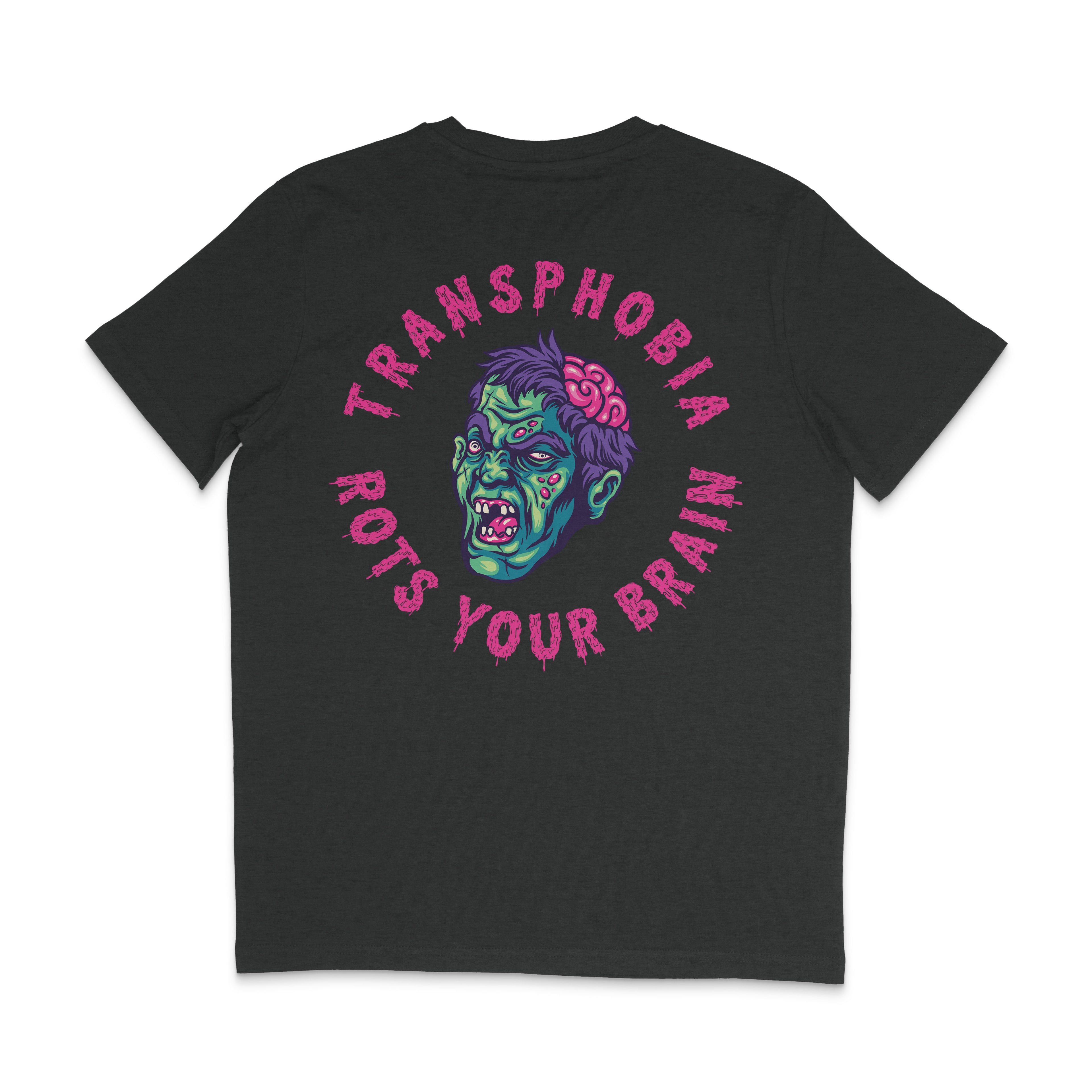 A dark heather grey t-shirt with a vibrant Halloween-themed design on the back. The design features a green zombie head with an exposed pink brain and the phrase "Transphobia Rots Your Brain" in bold, dripping pink letters surrounding the zombie. The text and image have a spooky, horror-inspired style.