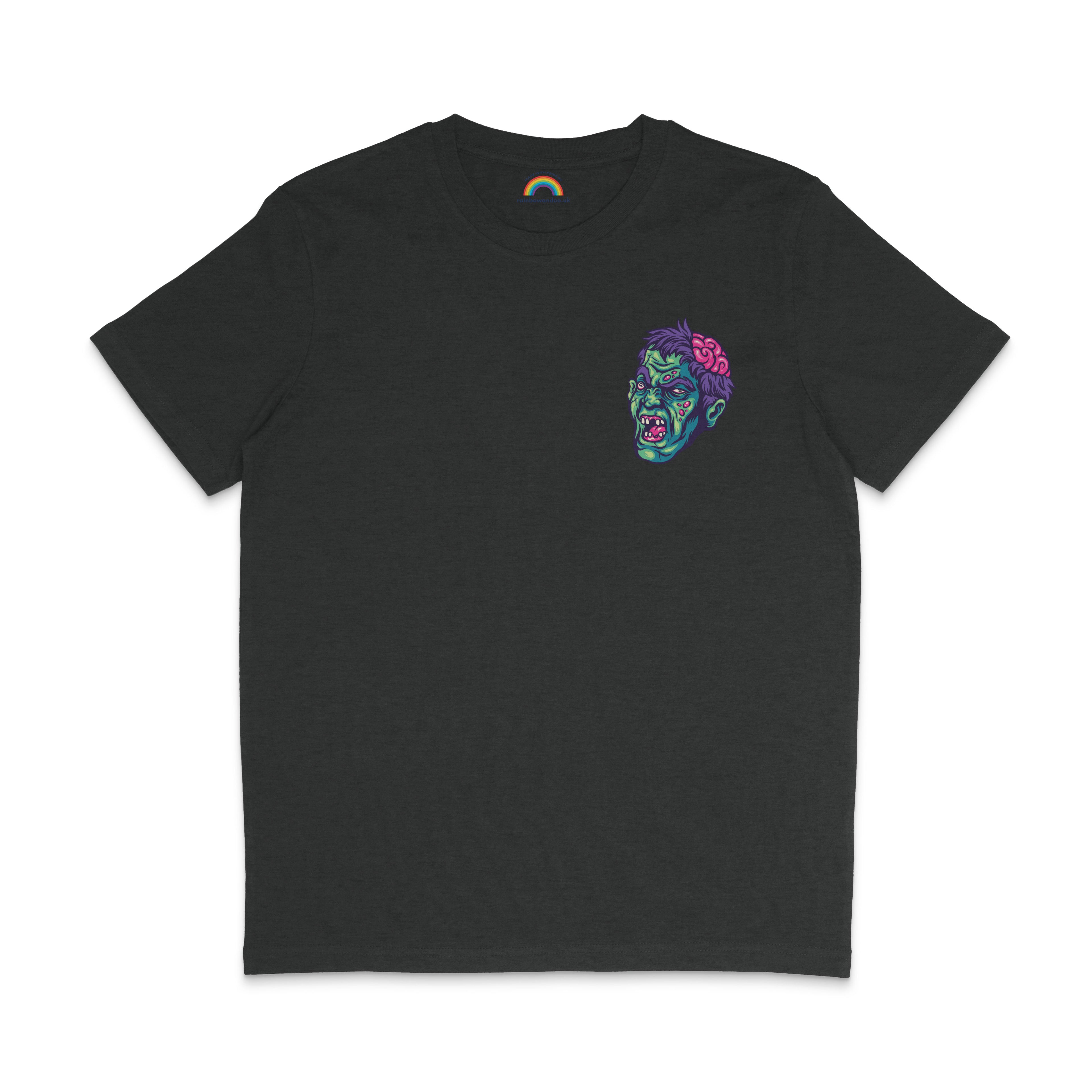 A dark heather grey t-shirt featuring a small, colourful zombie head design on the front left chest area. The zombie head has a green face, an exposed pink brain, and an eerie expression, adding a Halloween-themed element to the shirt.