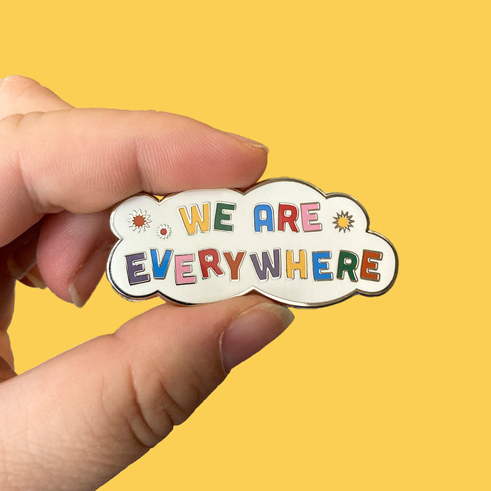 Cloud shaped enamel pin with colourful text reading We Are Everywhere