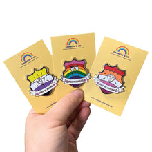 Load image into Gallery viewer, White hand holding up three yellow backing cards each showing a different shield shaped enamel pin; They of Honor, Pridesmate, and Gay of Honor. The pins are a part of the Rainbow &amp; Co Wedding Collection.