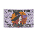Flag with a witch design and text 'Witches for Trans Rights' on a checkered background.