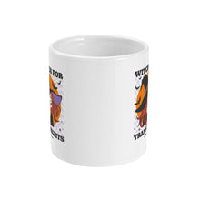 Load image into Gallery viewer, A white ceramic coffee mug with handle facing away from view. The mug shows the slogan Witches for Trans Rights with an illustrated graphic of a witch with bats flying around her hat