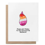 Happy Birthday to My Favourite Lesbean greeting card featuring a smiling bean in the colours of the lesbian flag wearing a party hat.