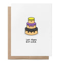 White greeting card featuring a three-tier cake decorated in the colours of the non-binary pride flag above the words "Let them eat cake." with a brown kraft envelope behind.