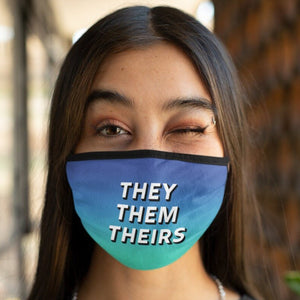 Person wearing a THEY THEM THEIRS face mask in a blue/green gradient colour.